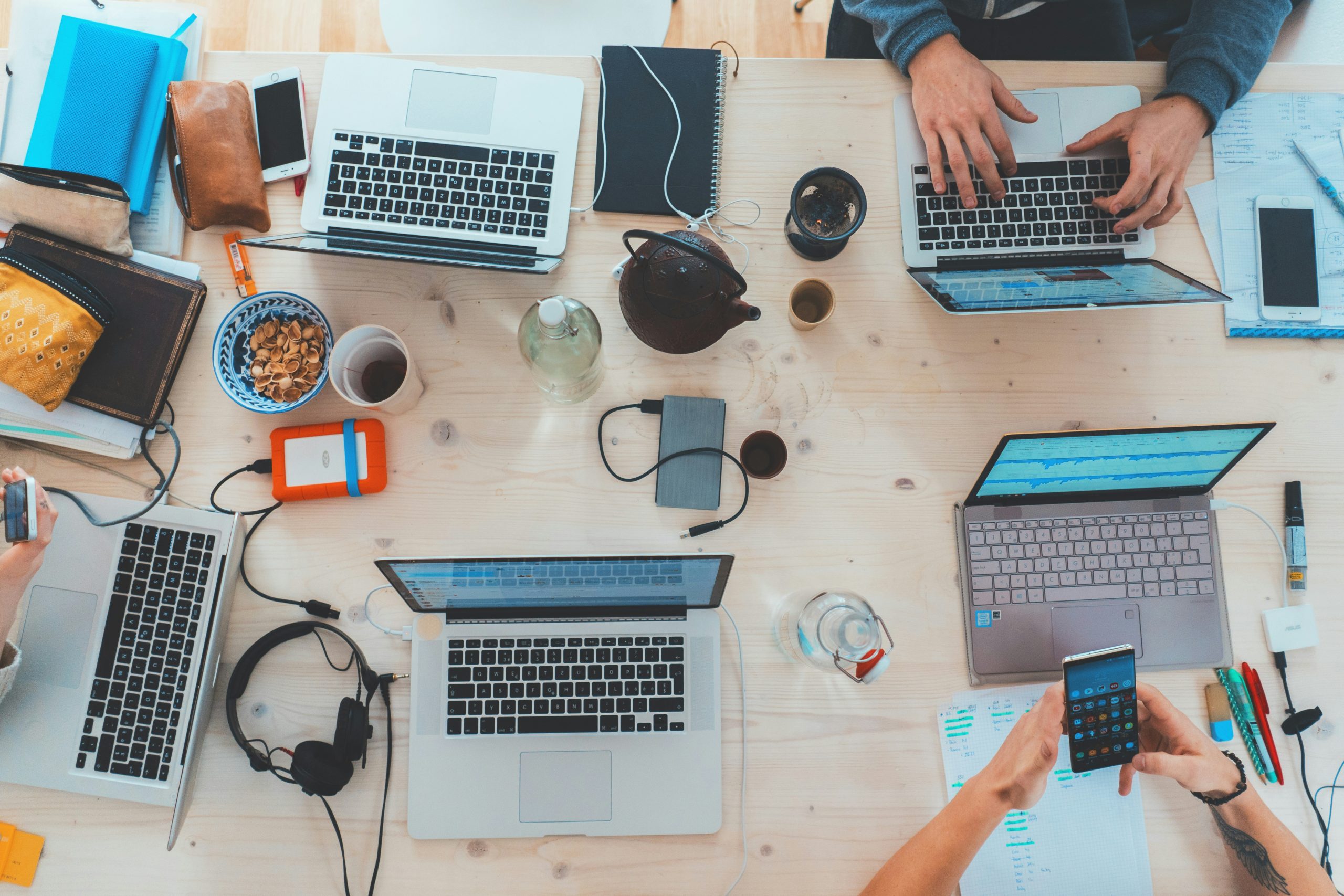 Photo by Marvin Meyer on https://unsplash.com/photos/people-sitting-down-near-table-with-assorted-laptop-computers-SYTO3xs06fU